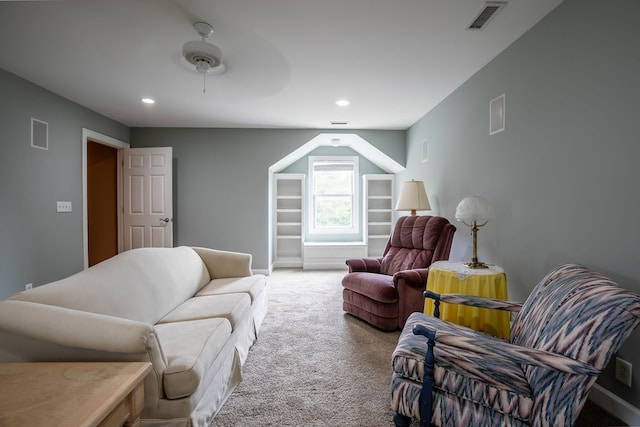 carpeted living room with ceiling fan