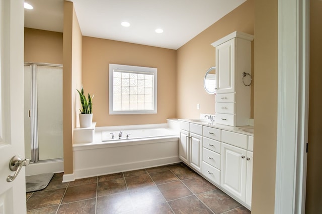 bathroom featuring plus walk in shower and vanity