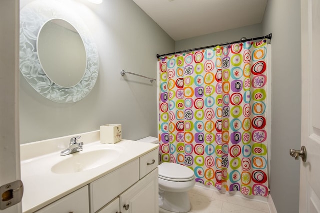 bathroom with vanity, toilet, walk in shower, and tile patterned flooring