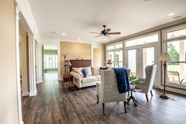 living room featuring crown molding, dark hardwood / wood-style flooring, plenty of natural light, and ceiling fan