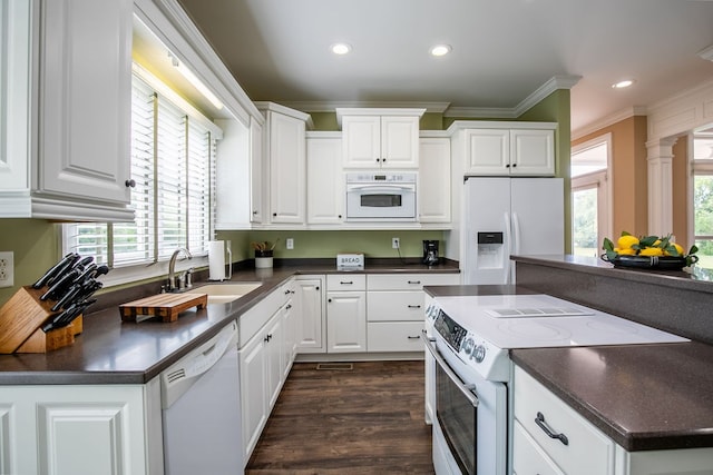 kitchen featuring white cabinets, white appliances, and a wealth of natural light