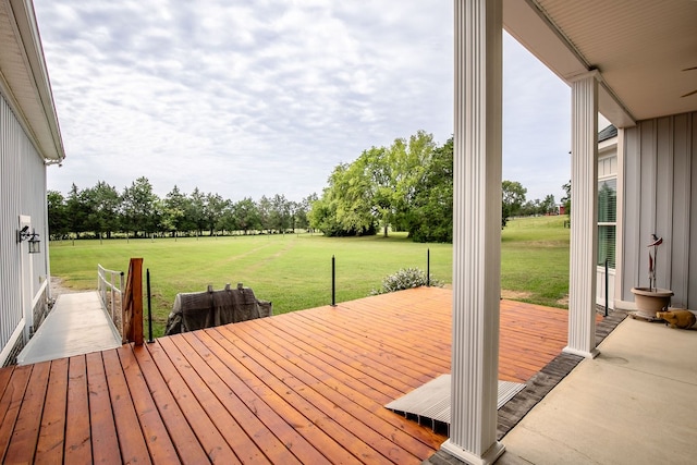 wooden terrace featuring a lawn