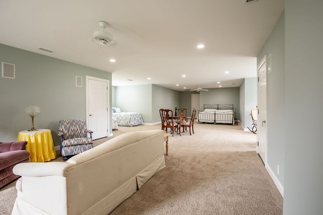 living room with light colored carpet and ceiling fan