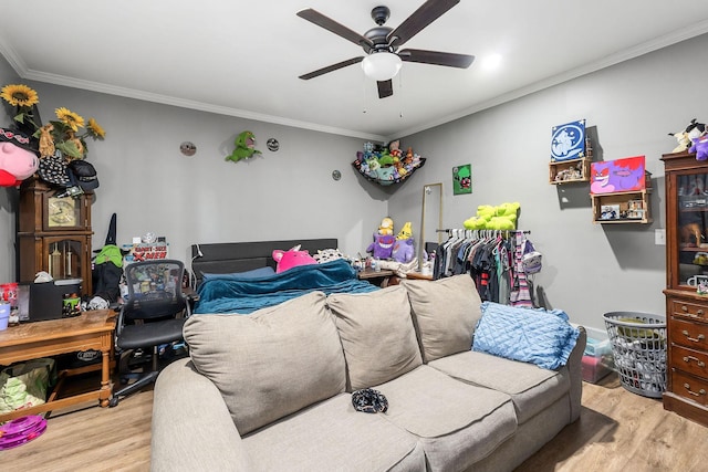 bedroom with ceiling fan, crown molding, and light wood finished floors