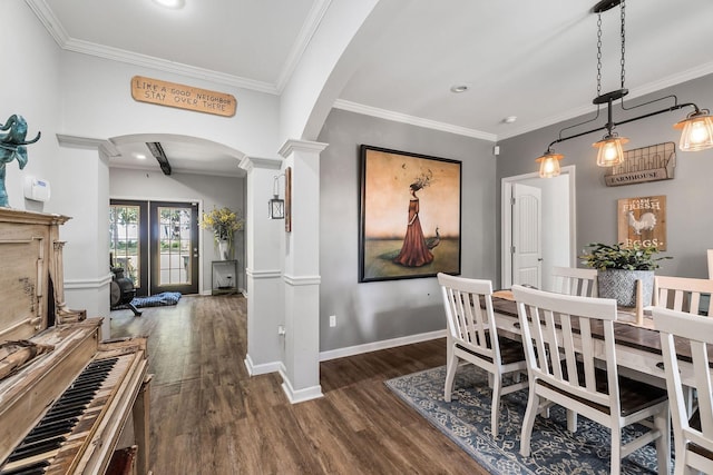 dining room featuring arched walkways, dark wood finished floors, ornamental molding, and decorative columns