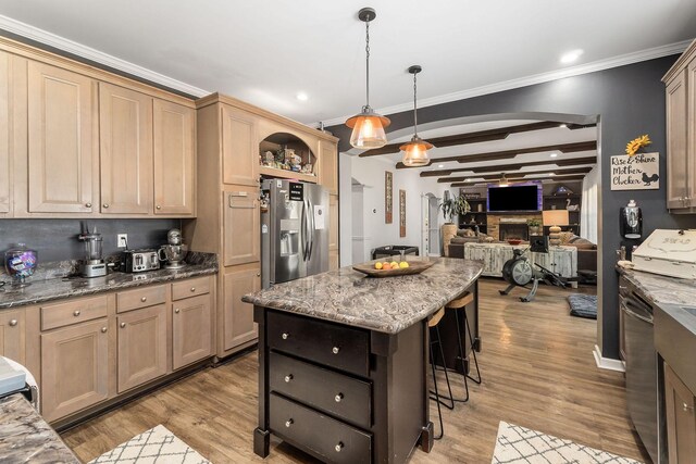 kitchen featuring a kitchen island, stainless steel fridge, light hardwood / wood-style flooring, beam ceiling, and crown molding