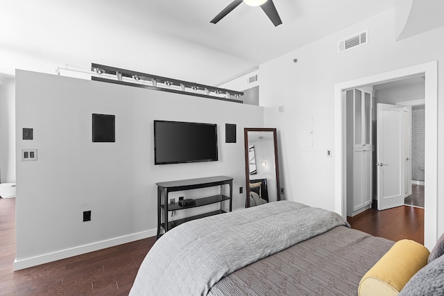 bedroom with ceiling fan, dark hardwood / wood-style floors, and ensuite bath