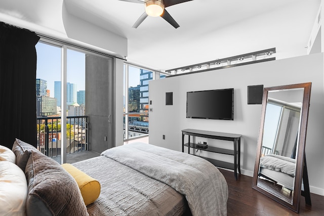 bedroom with ceiling fan, dark hardwood / wood-style floors, multiple windows, and access to outside