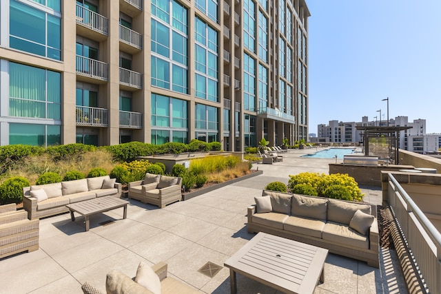 surrounding community featuring a patio area and outdoor lounge area