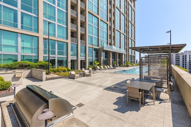 view of property's community featuring a patio and a pool