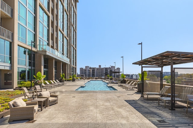 view of swimming pool featuring a patio area and a pergola