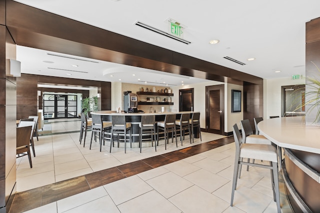 tiled dining space featuring indoor bar