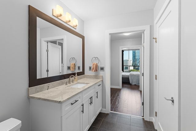 bathroom with hardwood / wood-style floors, toilet, and vanity