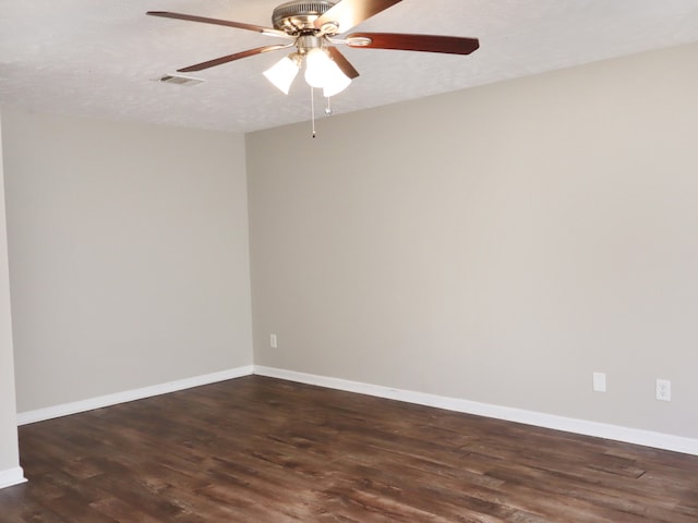 spare room with ceiling fan, dark hardwood / wood-style floors, and a textured ceiling