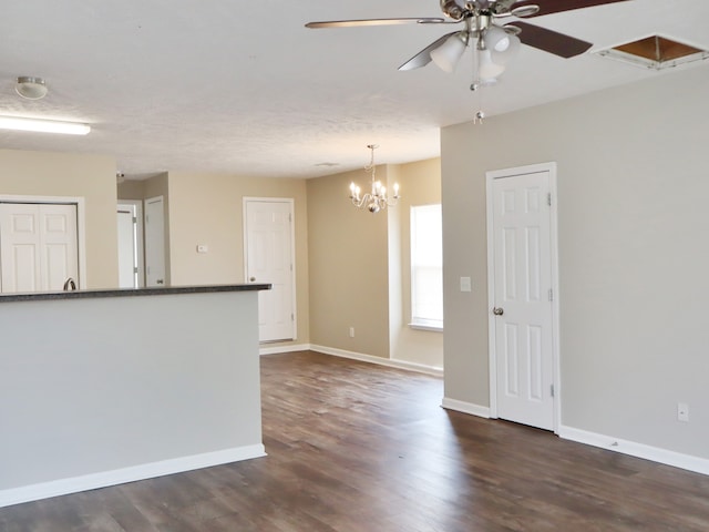 interior space featuring dark hardwood / wood-style floors and ceiling fan with notable chandelier