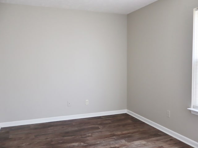 spare room featuring dark hardwood / wood-style flooring