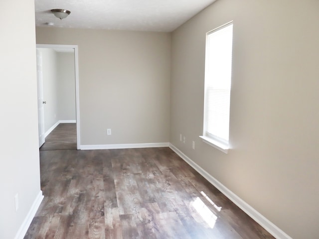 spare room with dark hardwood / wood-style flooring