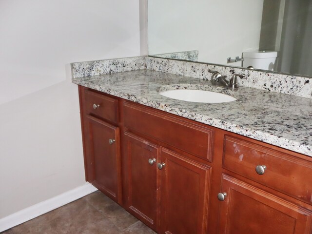 bathroom featuring toilet and vanity