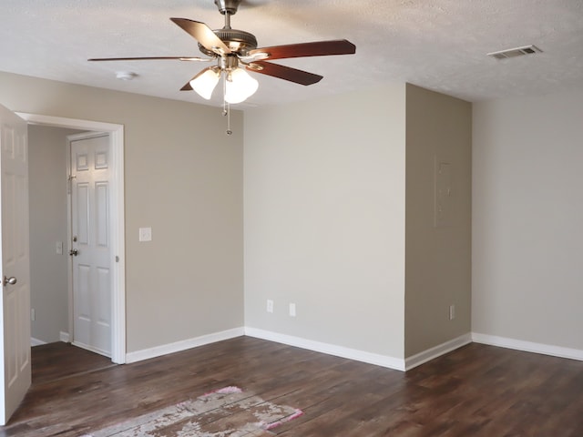 spare room featuring a textured ceiling, ceiling fan, and dark hardwood / wood-style flooring