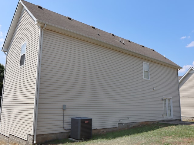 view of home's exterior with central AC and french doors