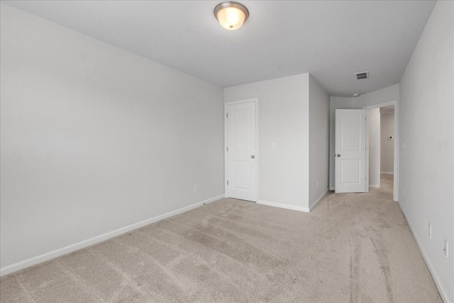 unfurnished bedroom featuring light carpet, baseboards, and visible vents