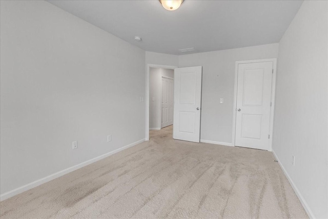 unfurnished bedroom featuring carpet and baseboards