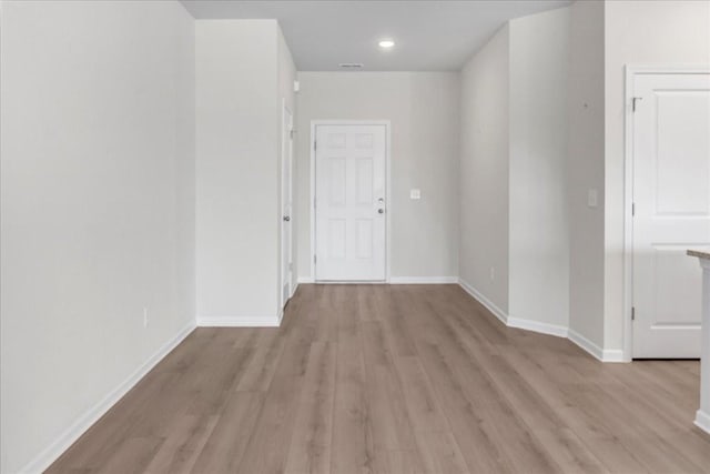 spare room with light wood-style floors, visible vents, baseboards, and recessed lighting