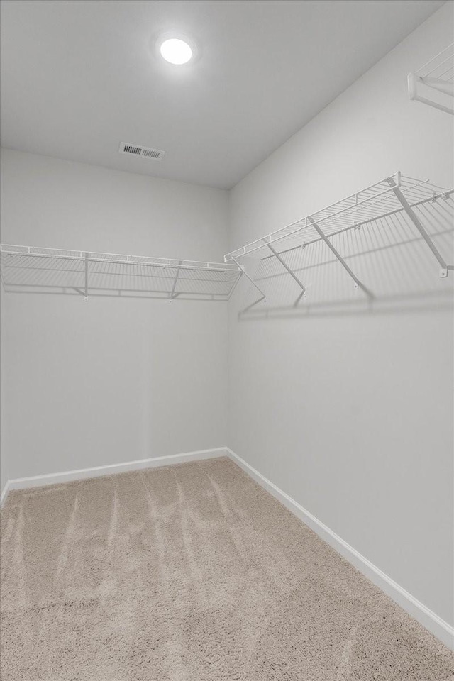 walk in closet with carpet floors and visible vents