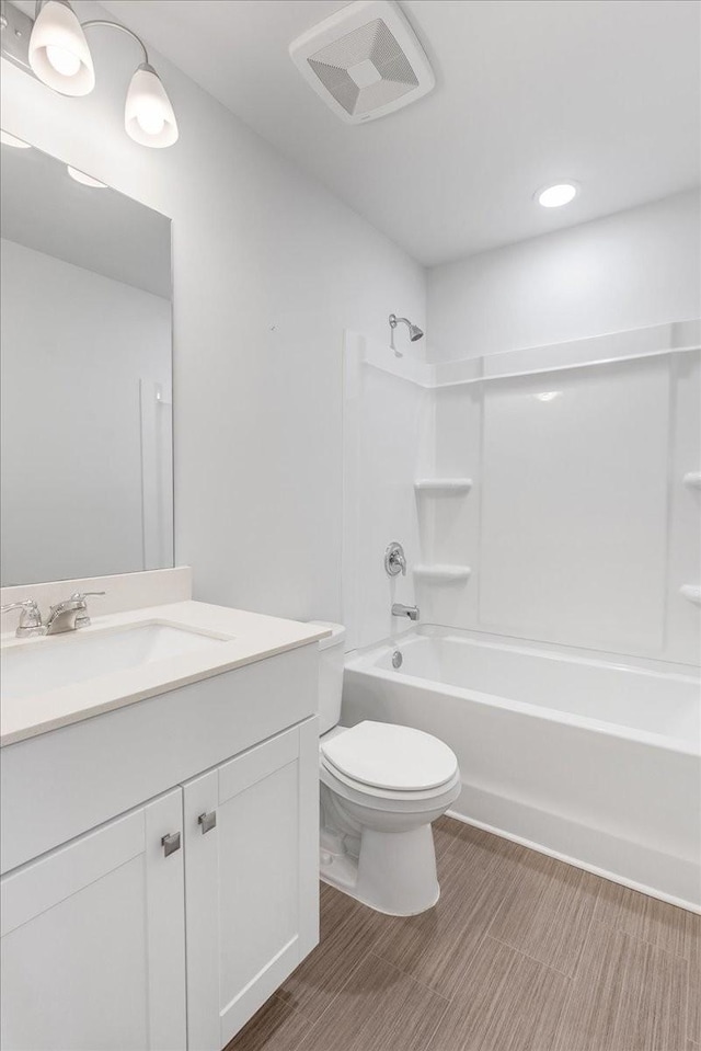 full bath with toilet, shower / tub combination, visible vents, and vanity