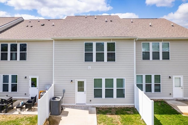 back of property featuring a shingled roof, a patio, and central air condition unit