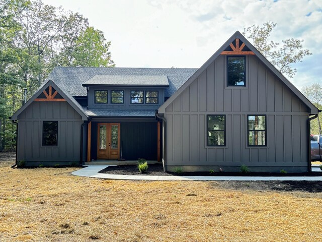 modern farmhouse style home featuring a front yard and french doors