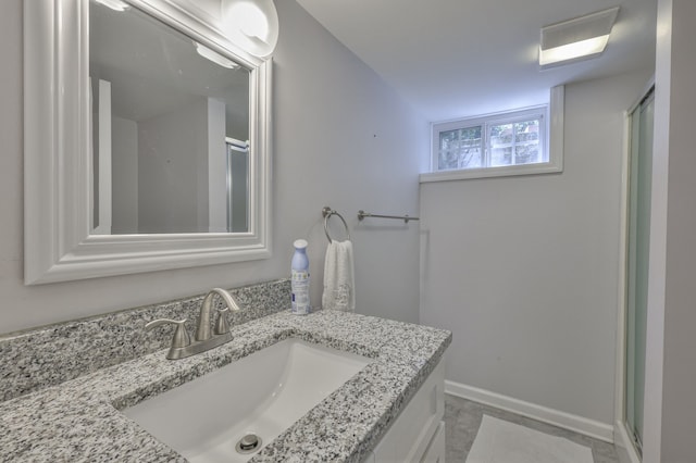 bathroom featuring vanity and an enclosed shower