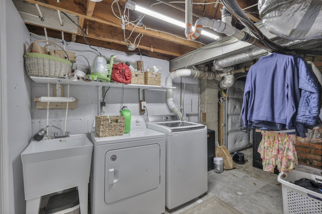 clothes washing area with sink and washer and dryer