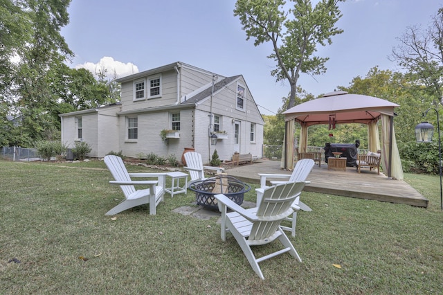 view of yard featuring a fire pit, a gazebo, and a deck