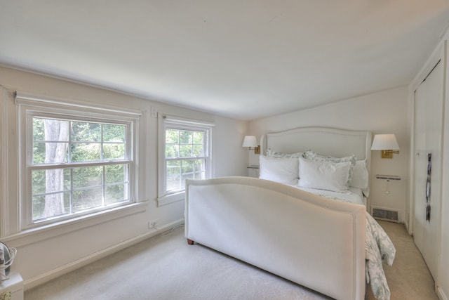 bedroom with light colored carpet