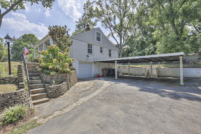 view of property exterior with a garage and a carport