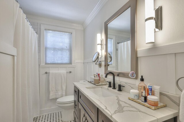 bathroom featuring toilet, ornamental molding, and vanity