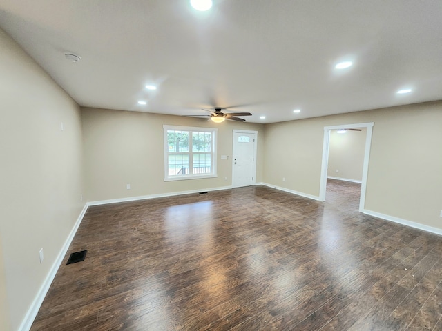 empty room featuring ceiling fan and dark hardwood / wood-style floors