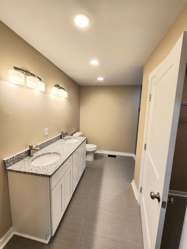 bathroom with vanity and toilet