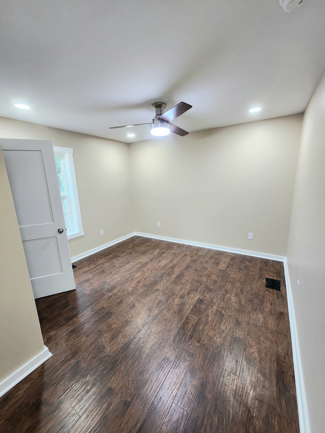 unfurnished room with ceiling fan and dark hardwood / wood-style flooring