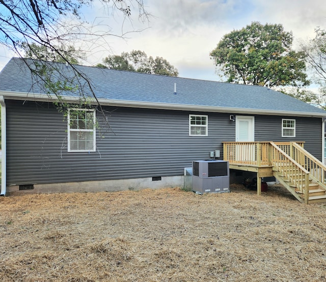 back of house featuring a deck and central AC unit