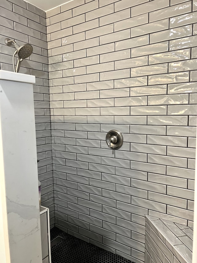 bathroom with a tile shower