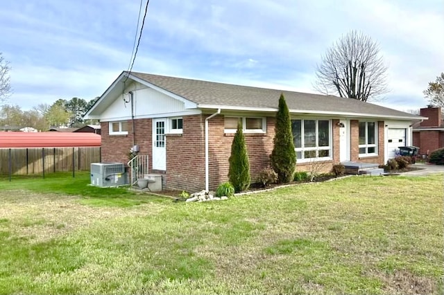 rear view of property featuring cooling unit and a lawn