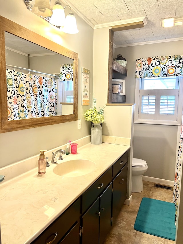 bathroom with a textured ceiling, vanity, toilet, and ornamental molding