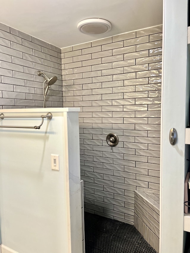 bathroom with tiled shower