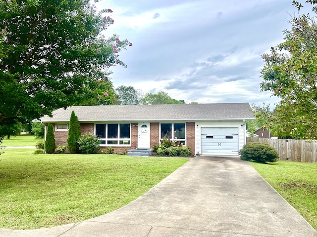 single story home featuring a garage and a front lawn