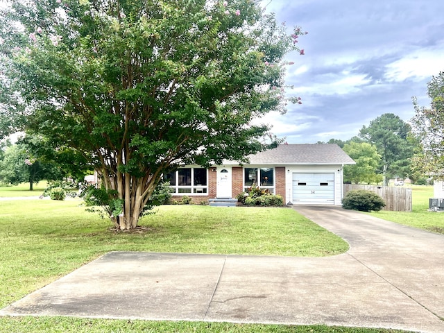 single story home with cooling unit, a front yard, and a garage