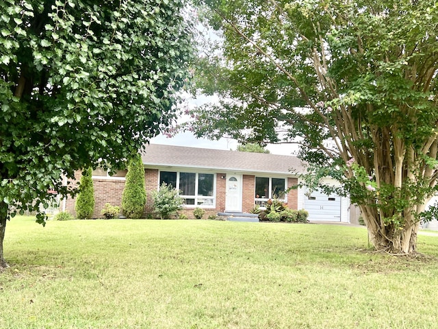 single story home featuring a front lawn and a garage