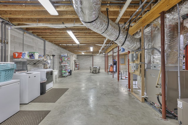 basement featuring washer and dryer and white refrigerator