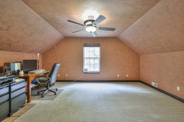 home office featuring lofted ceiling, ceiling fan, and carpet